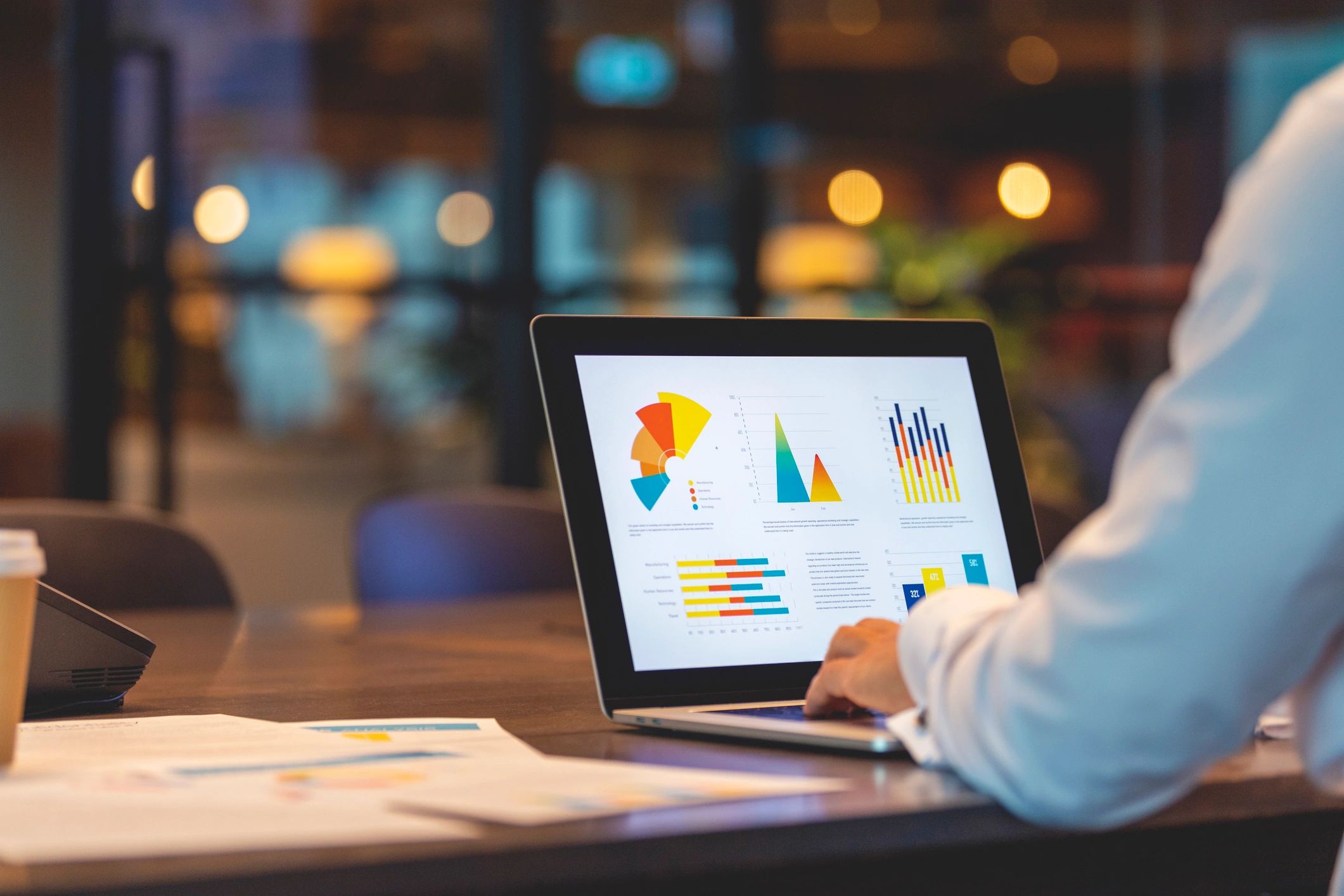Laptop showing charts and business metrics for pricing decisions